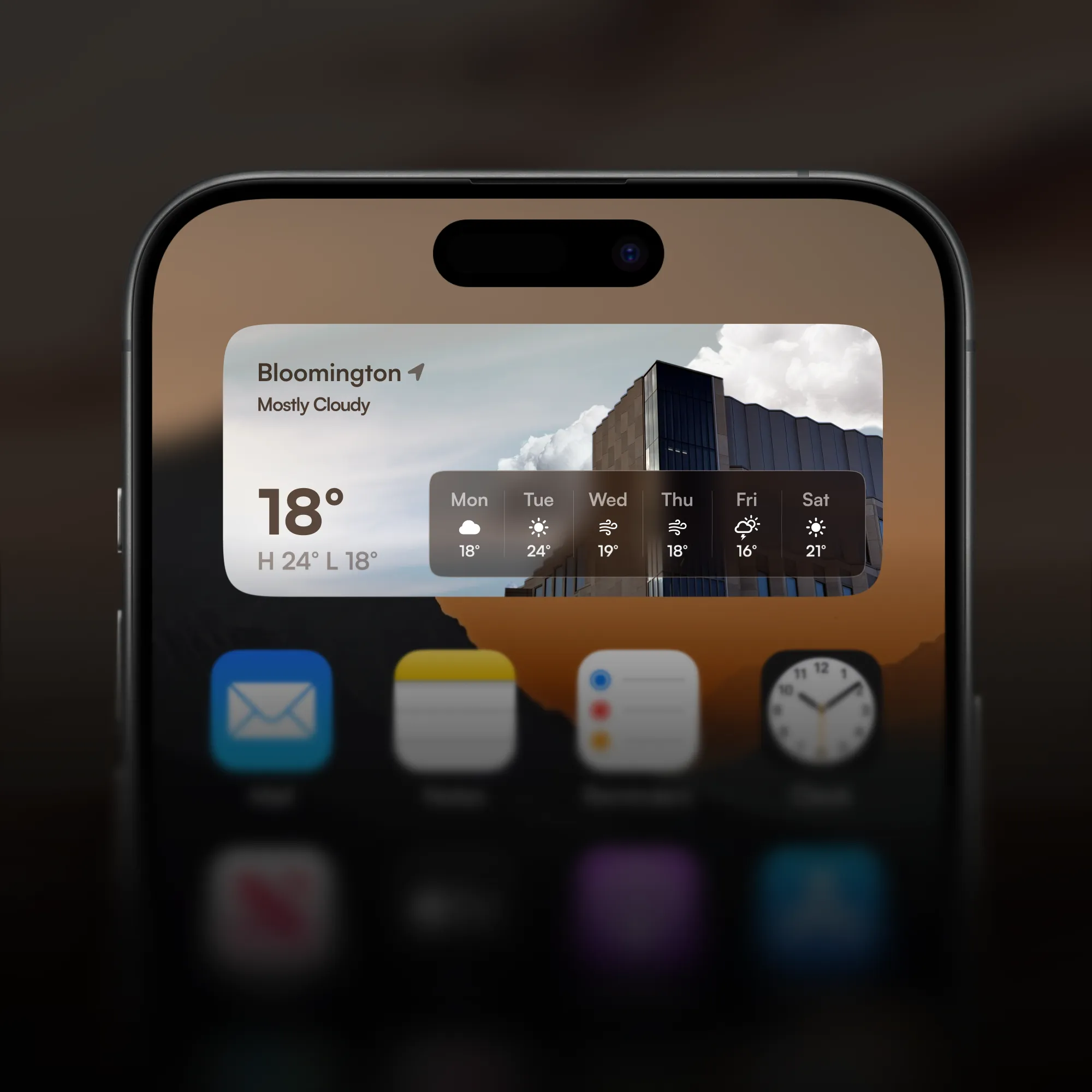 iPhone weather widget showing 18° and mostly cloudy in Bloomington, set against a local landmark